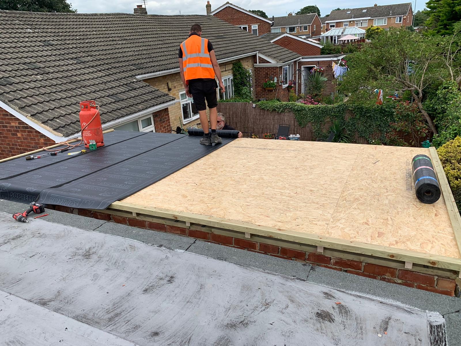 An EPDM rubber flat roof membrane installation
