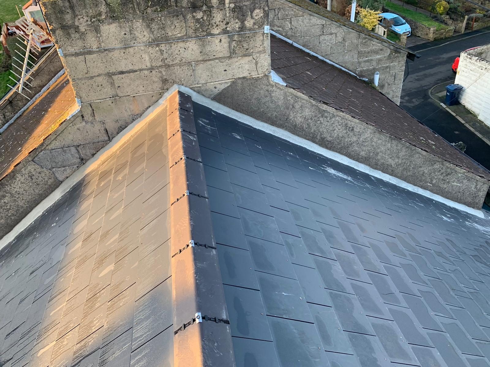 A new slate roof being installed on a property